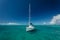 White sailboat moored in beautiful tropical turquoise ocean waters in British Virgin Islands