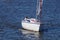 A white sailboat sailing on blue water