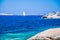 White sailboat, yacht between granite rocks in sea, amazing azure water, Sardinia, Italy