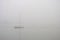 White Sailing Boat in The Fog