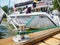 A white sailing boat moored with a line tied around a metal fixing. Mooring rope and bollard for recreational boats at the harbor