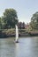 A white sails sailboat maneuvers on the River Thames near Richmond, London