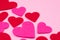 White Saint Valentine`s day background with red and pink hearths, close-up view, copy space