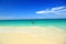 White sand beach of Aruba Island.Turquoise sea water and blue sky. Couple in yellow kayak.