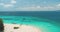 White sand beach and coral reef aerial. Turquoise transparent ocean water and luxury yacht boats