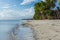 White sand beach meets calm clear sea.