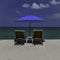 White sand beach, sunloungers and blue parasol
