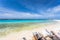 White sand beach and turquoise waves. Turquoise sea water and blue sky. Curacao island.