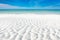 White sand curve or tropical sandy beach with blurry blue ocean and blue sky background image for nature background or summer