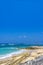 White sand, turquoise waters against the blue sky at Pandawa Beach, Bali, Indonesia.