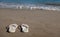 White sandals on a golden sandy beach