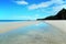 White Sands Beach With Sky Reflected in the Water.