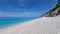 White sandy beach with a blue sea in Nidri, Lefkada island, Greece