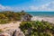 White sandy beach, palm trees, yucca plants and Mayan ruins in the background. Riviera Maya on the Caribbean. Tulum, Yucatan, Mexi