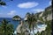 white sandy beach with turquoise waters enclosed by a steep cliff and headland ,Secluded white