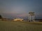 white sandy beachside view in the evening with bridge lights and stage performances