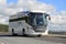 White Scania Touring Bus on the Road at Summer