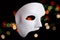 White Scary Halloween mask on bokeh background.