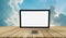 White screen computer on wooden table, blurred sky background ,empty space for text and image,use advertising media,montage for