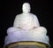 White sculpture of a seated Buddha on a background of the night sky. Pagoda Long Son, Vietnam