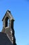 White seagull perches on an ancient church tower, Ireland.