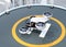 White self-driving passenger drone takeoff from helipad