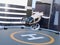 White self-driving passenger drone takeoff and landing on the helipad