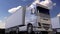 White semi trucks loading or unloading. Cargo logistics concept. 3d rendering
