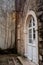 White semicircular door with glass in the stone wall of the old town in Budva, Montenegro