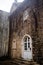 White semicircular door with glass in the stone wall of the old town in Budva, Montenegro