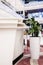 A white service counter with pots of the same material on a red carpet