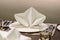 White serviette decorated on dinner set table