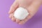 White shaving foam in the hand of a teenager on a blue bright background