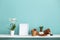 White shelf against pastel turquoise wall with pottery and succulent plant with potted orchid