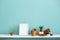 White shelf against pastel turquoise wall with pottery and succulent plant with potted spider plant