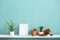 White shelf against pastel turquoise wall with pottery and succulent plant with potted spider plant