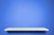 White shelf on blue cement background for product display