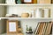 White shelving unit with books and decorative elements