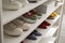 White shelving unit with collection of colorful sneakers