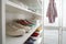 White shelving unit with collection of colorful sneakers
