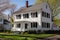 white shingles of a colonial revival home