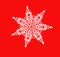 White shiny snowflake close-up on a red background