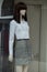 white shirt and grey skirt on annequin in fashion sto