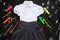 White shirt, grey skirt and stationery supplies on black background. The first of september, new school year