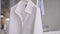 White shirt on the hanger in the atelier studio, blurred background