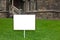 White sign on green lawn background