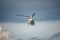 White Sikorsky S-76B helicopter fly over the sky with huge rain cloud