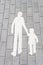 White silhouette walking adult and child on tile