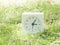 White simple clock on lawn yard, 3:05 three five