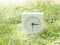 White simple clock on lawn yard, 3:15 three fifteen